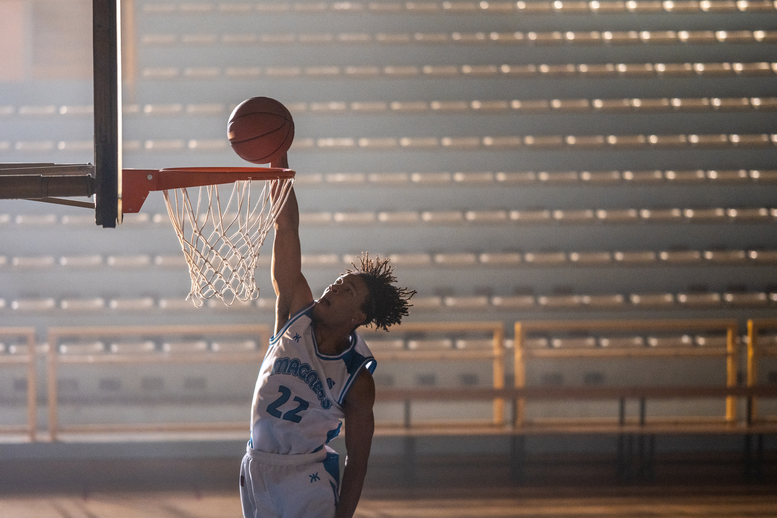 Basketball player dunking basketball