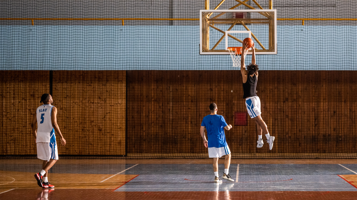 Basketball player scoring slam dunk