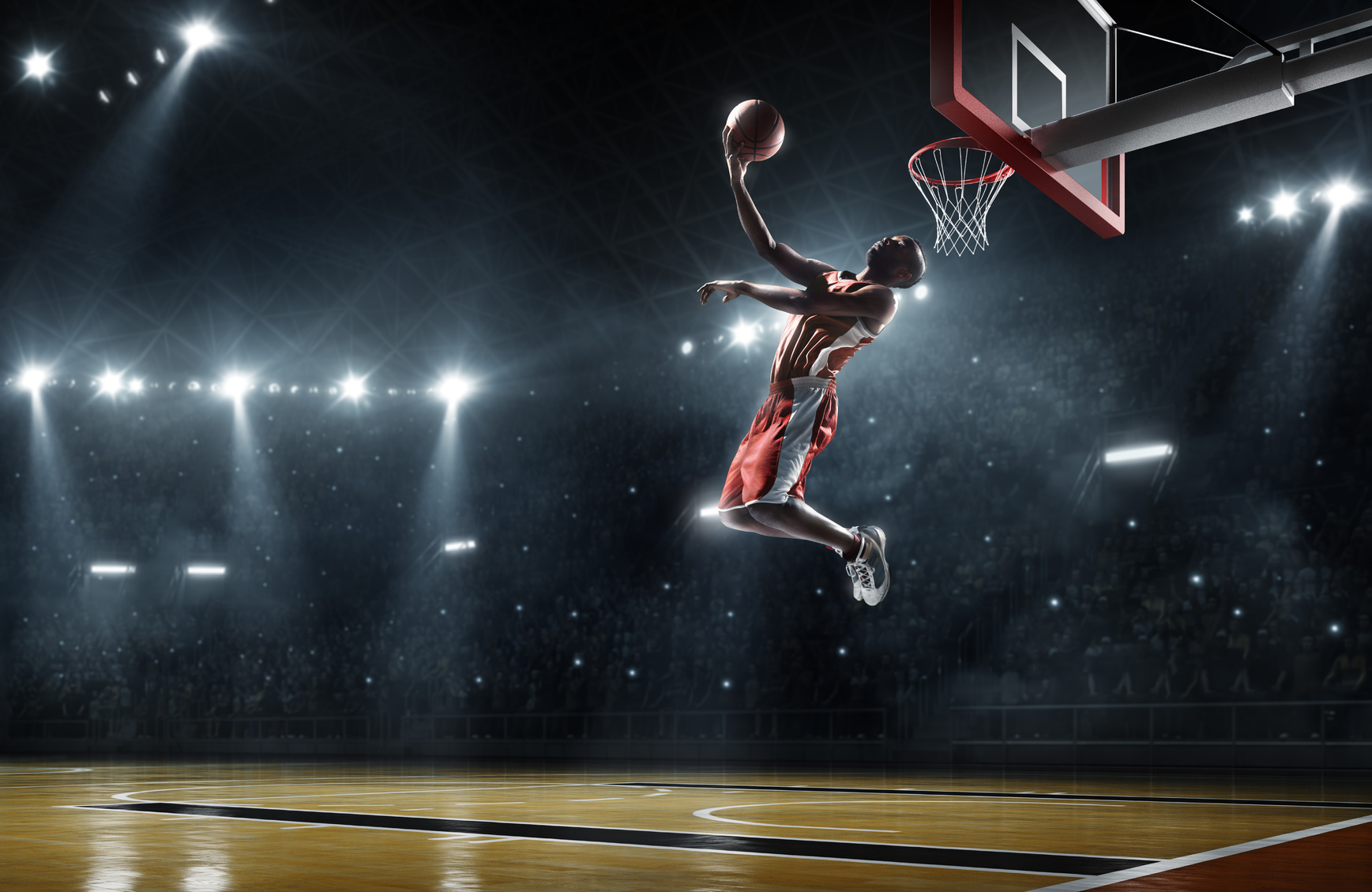 Basketball player makes slam dunk